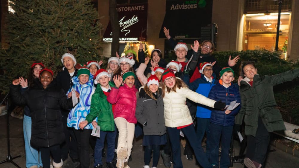 The choir waving and cheering after their carol performance