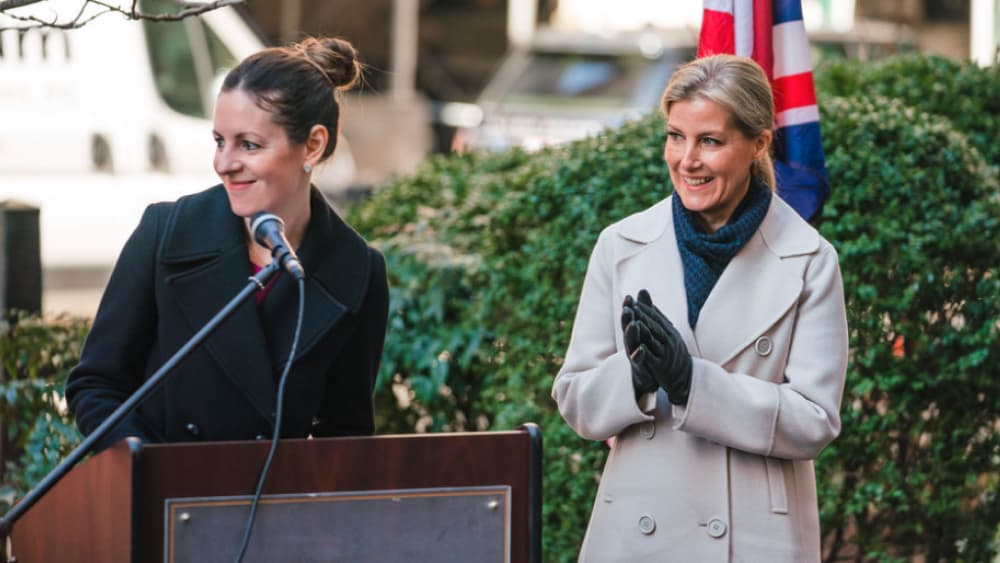 A speaker addressing guests as Princess Sophie applauds