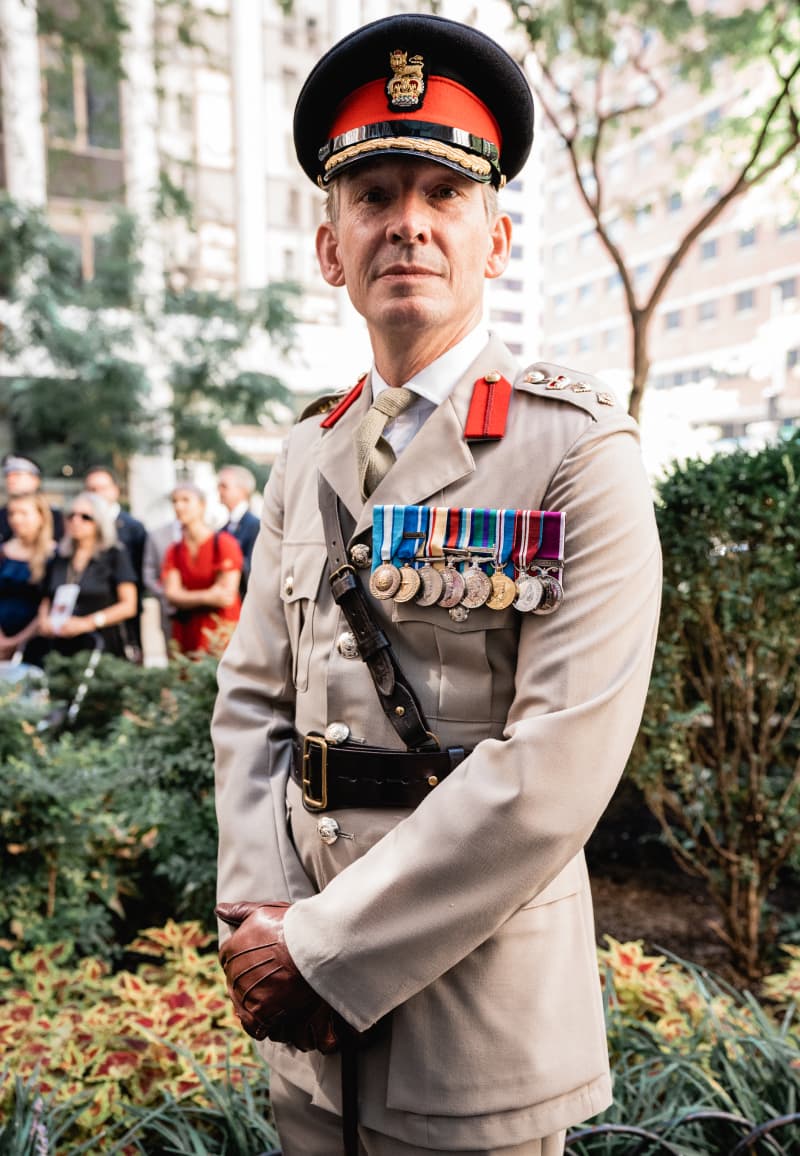 An officer in dress uniform at a garden ceremony